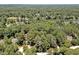 Aerial view of a wooded property featuring mature trees and located near a golf course and a lake at 81106 Alexander, Chapel Hill, NC 27517