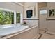 Bright bathroom featuring a soaking tub with mosaic tile surround, a heated towel rack, and a glass door shower at 81106 Alexander, Chapel Hill, NC 27517