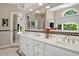 Elegant bathroom showcasing a double vanity with white cabinets, mosaic tile, and a large mirror, creating an open space at 81106 Alexander, Chapel Hill, NC 27517