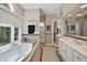 Bright bathroom with a soaking tub, double vanity, mosaic tile accents, and a walk in shower at 81106 Alexander, Chapel Hill, NC 27517