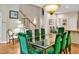 Dining area with a glass table, green chairs, and a staircase in view at 81106 Alexander, Chapel Hill, NC 27517