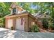 Charming brick home featuring a two-car garage, dormer window, landscaped yard, and American flag at 81106 Alexander, Chapel Hill, NC 27517