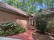 Brick home with lush landscaping, a red brick walkway, and a red-framed front door at 81106 Alexander, Chapel Hill, NC 27517