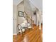 Foyer view showing hardwood floors, staircase with white banister, and sitting chairs at 81106 Alexander, Chapel Hill, NC 27517