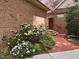 Brick home featuring a red brick walkway, lush landscaping, and a charming entrance at 81106 Alexander, Chapel Hill, NC 27517