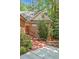 Charming brick home with a red brick pathway and lush landscaping leading to the front door at 81106 Alexander, Chapel Hill, NC 27517