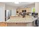 Open kitchen featuring stainless steel appliances, light wood cabinets and a large island at 81106 Alexander, Chapel Hill, NC 27517