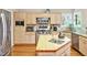 Bright kitchen with stainless steel appliances, natural wood cabinets and an island sink at 81106 Alexander, Chapel Hill, NC 27517