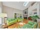 Cozy living room features a stone fireplace, skylights, hardwood floors, and floral couches at 81106 Alexander, Chapel Hill, NC 27517
