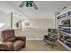 Loft area featuring comfortable seating, a ceiling fan, and built-in bookshelves at 81106 Alexander, Chapel Hill, NC 27517