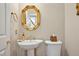 Powder room features a gold trimmed mirror, gold faucet, and pedestal sink at 81106 Alexander, Chapel Hill, NC 27517