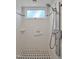 This is a bright shower with white tile, mosaic accents, a shower head and a window at 81106 Alexander, Chapel Hill, NC 27517