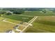 Aerial view of property showing home, surrounding fields, and long driveway at 82 Mamie Rd, Benson, NC 27504
