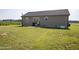 Spacious backyard featuring lawn and the back of the home at 82 Mamie Rd, Benson, NC 27504