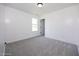 Bright bedroom featuring neutral tones, plush carpet, and a window at 82 Mamie Rd, Benson, NC 27504
