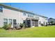 View of the back of the house from the backyard, featuring the screened in patio at 835 New Derby Ln, Apex, NC 27523