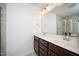 Bathroom featuring a double vanity with white countertop, brown cabinets and a glass enclosed shower at 835 New Derby Ln, Apex, NC 27523