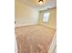 Bedroom features plush carpeting, neutral walls, white trim and a window providing natural light at 835 New Derby Ln, Apex, NC 27523