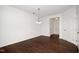 Bright dining room with hardwood floors and modern lighting fixture near entryway at 835 New Derby Ln, Apex, NC 27523