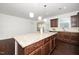 Granite island in the kitchen with pendant lights and stainless steel appliances at 835 New Derby Ln, Apex, NC 27523