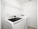 Bright laundry area featuring a Samsung washer and dryer and wire shelving for convenient storage at 835 New Derby Ln, Apex, NC 27523