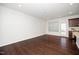 Bright living room featuring hardwood floors, and a view into the kitchen area at 835 New Derby Ln, Apex, NC 27523