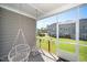Covered patio offers a peaceful view of the lush green backyard, featuring a hanging swing at 835 New Derby Ln, Apex, NC 27523