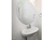 Modern powder room with a pedestal sink, oval mirror, and chrome fixtures at 835 New Derby Ln, Apex, NC 27523