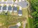 Overhead view of homes in a neighborhood beside a pond and green space at 84 Elliot Dr Dr, Clayton, NC 27520