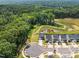 Aerial view of a neighborhood with well-maintained homes, green spaces, and a scenic pond at 84 Elliot Dr Dr, Clayton, NC 27520