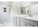 This bright bathroom has a luxurious marble shower and grey cabinets with white counters at 84 Elliot Dr Dr, Clayton, NC 27520