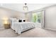 A cozy bedroom with carpet, large window and a decorative chandelier at 84 Elliot Dr Dr, Clayton, NC 27520