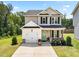 Inviting two-story home featuring a lush green lawn, a one-car garage, and a lovely green front door at 84 Elliot Dr Dr, Clayton, NC 27520