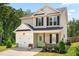 Attractive two-story home with an attached garage, a charming green door, and lovely landscaping at 84 Elliot Dr Dr, Clayton, NC 27520
