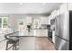 Bright kitchen showcases stainless steel appliances, granite countertops, a kitchen island with chairs, and access to the backyard at 84 Elliot Dr Dr, Clayton, NC 27520
