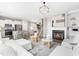 Bright living room with a fireplace, elegant decor, and open access to the kitchen and dining area at 84 Elliot Dr Dr, Clayton, NC 27520