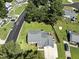 Aerial shot showcasing the home's well-manicured lawn, driveway, and street with mature trees at 1 Saturn Court Ct, Durham, NC 27703