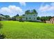 Lush backyard featuring a well-maintained lawn and mature trees, perfect for outdoor enjoyment at 1 Saturn Court Ct, Durham, NC 27703