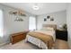 Comfortable bedroom with neutral walls, carpet, and stylish decor on shelves and walls at 1 Saturn Court Ct, Durham, NC 27703