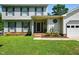 Inviting front porch of a two-story home with manicured lawn and landscaping at 1 Saturn Court Ct, Durham, NC 27703