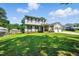Two-story home with attached two-car garage, lush green lawn, and mature trees at 1 Saturn Court Ct, Durham, NC 27703