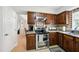 Updated kitchen featuring stainless steel appliances, granite countertops, and wood cabinetry at 1 Saturn Court Ct, Durham, NC 27703