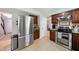 Bright kitchen with stainless steel appliances, tile floors, and ample cabinet space at 1 Saturn Court Ct, Durham, NC 27703