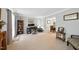Cozy living room featuring carpet flooring, neutral paint, and dining area view at 1 Saturn Court Ct, Durham, NC 27703