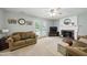Cozy living room with a fireplace, comfortable sofas, and bright lighting at 1 Saturn Court Ct, Durham, NC 27703