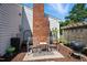 Cozy outdoor patio with seating, a grill, and a decorative brick chimney, ideal for entertaining at 1 Saturn Court Ct, Durham, NC 27703