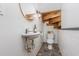 Compact bathroom features a toilet and sink with stairs behind at 1012 King Cir, Chapel Hill, NC 27516