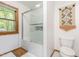 Bright bathroom with tile shower, glass doors, and a decorative wall hanging at 1012 King Cir, Chapel Hill, NC 27516