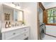 Bright bathroom with double sink vanity, mirror and a laundry room at 1012 King Cir, Chapel Hill, NC 27516