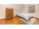 Cozy bedroom features hardwood floors, dresser and a large window at 1012 King Cir, Chapel Hill, NC 27516